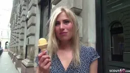 Blonde Frau mit Eis vor alter Steinfassade
